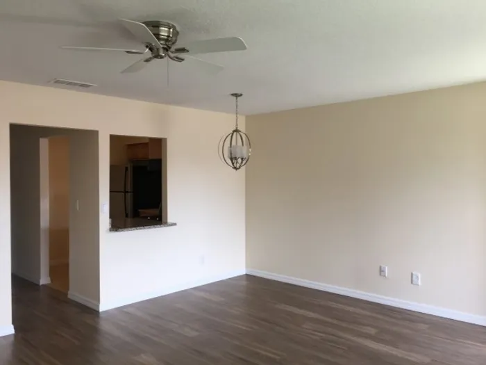 Marcell Gardens Apartments, interior, living room, wood floor, ceiling fan, pass through opening to kitchen