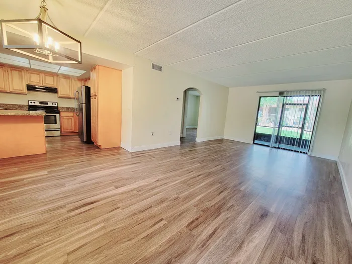 Marcell Gardens Apartments, interior, open concept living/dining/kitchen, carpet