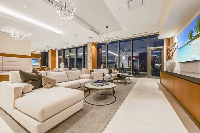 Resident lounge with plentiful seating and working areas, TV and cityscape views
