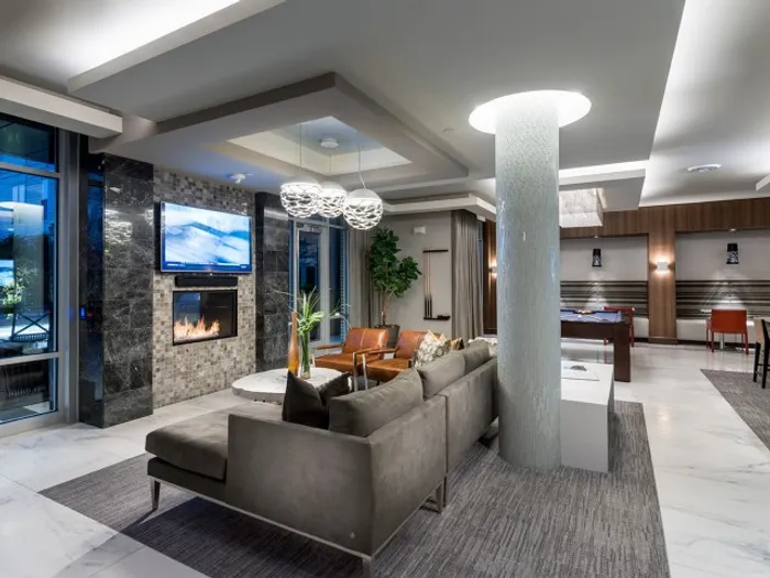 Billiards lounge with seating area, see-thru fireplace, pool table and flat-screen TV.