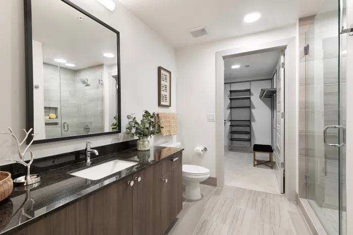 Spa-inspired bathrooms with soaking tubs and glass-framed showers with floor to ceiling tile