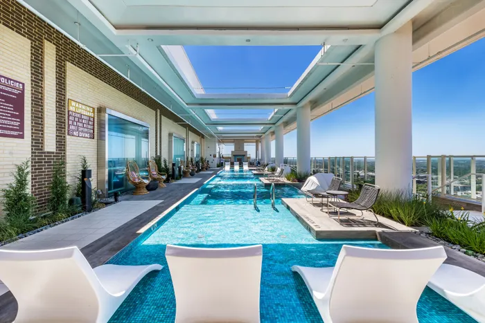 Roof-top pool featuring a sun shelf