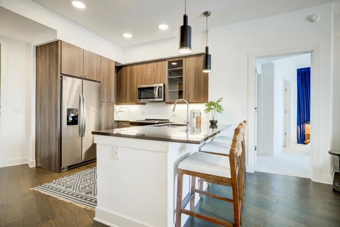 Granite countertops with coordinating tile backsplash and contemporary custom kitchen cabinetry