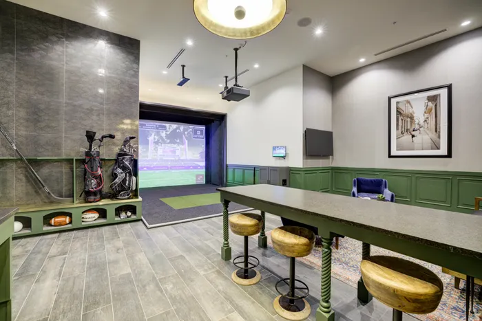 Sports lounge featuring golf simulator and social seating areas