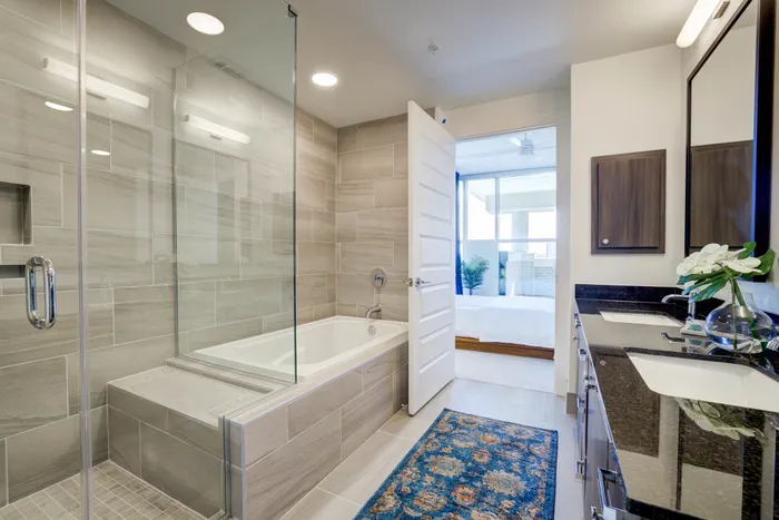 Spa-inspired bathrooms with soaking tubs and glass-framed showers with floor to ceiling tile