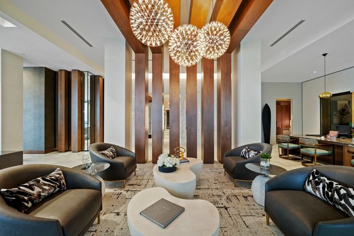 lobby with wood panels and spherical lights and sofa seating