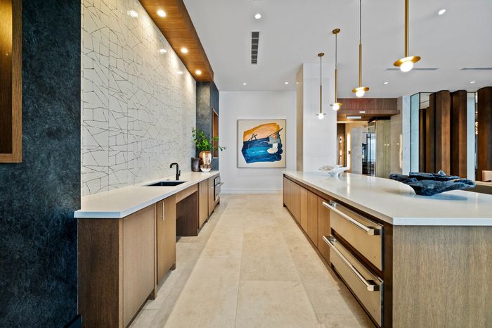 entertaining kitchen with warming drawers and sink and counter seating