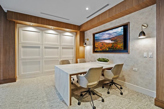 meeting room with tv and table and 4 chairs
