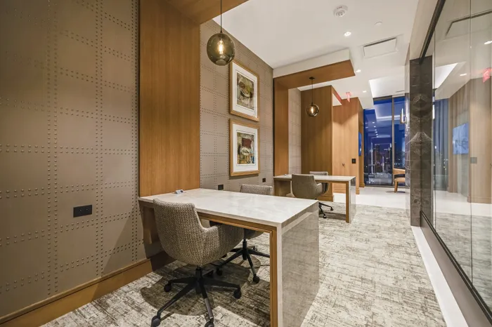 room with two built-in desks with task chairs
