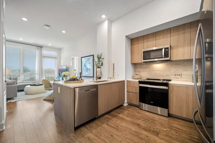 kitchen with light brown cabinets, white counters, and stainless steel appliances