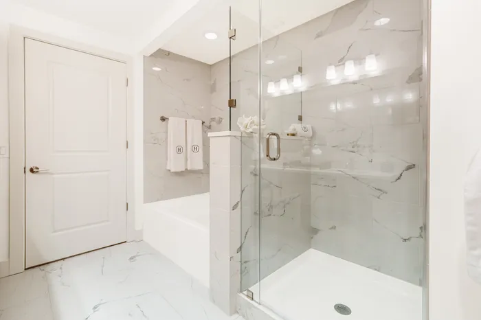 bathroom with tub and stand up shower
