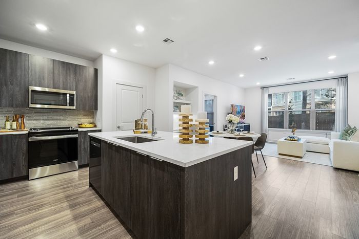 kitchen counter with the sink, stove/oven and microwave