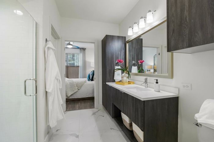 Photo of bathroom counters with two sinks with standing shower