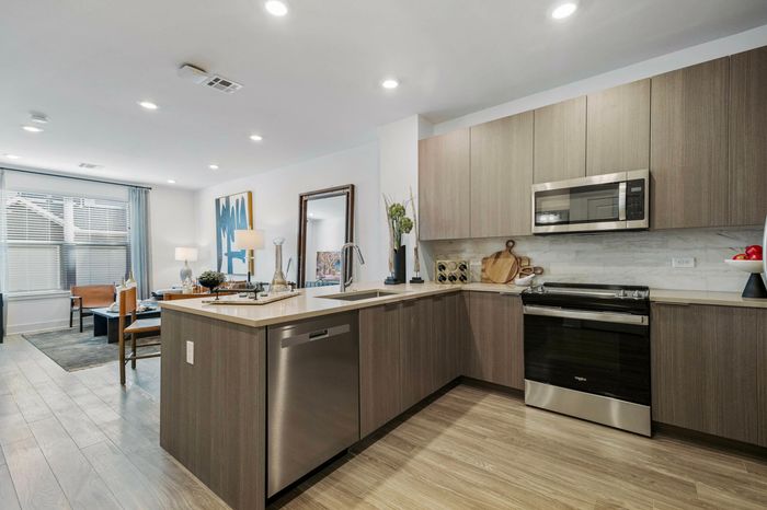 kitchen counter with the sink, stove/oven and microwave