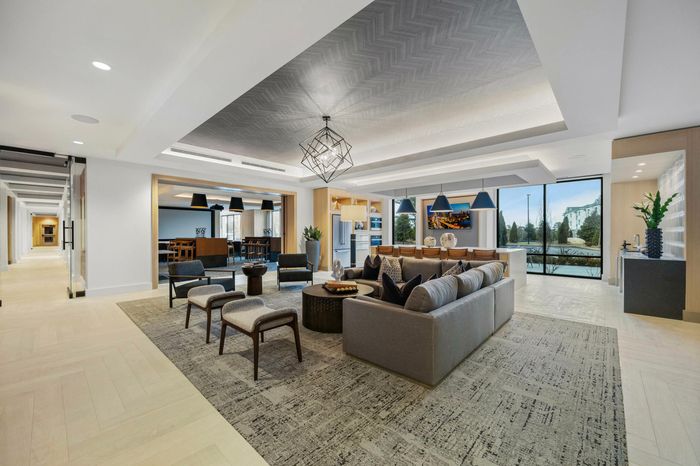 photo of Club House room that has big area with sofia a kitchen area with tables and coutners