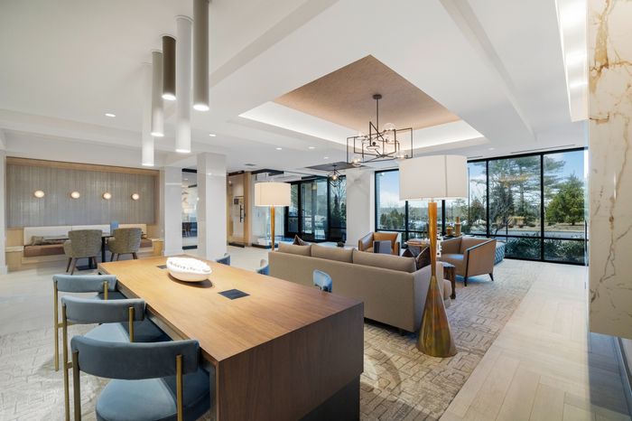 lounge area with booth seating, communal coworking table, and sofa seating