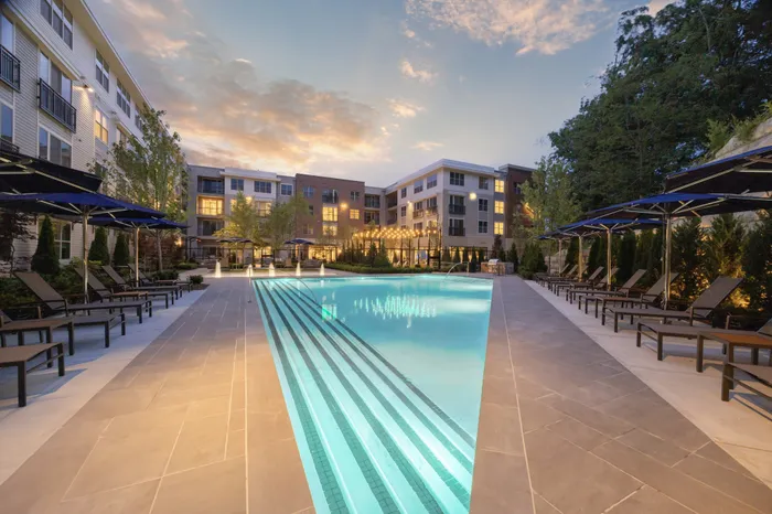large resort style pool surrounded with sun loungers and umbrellas