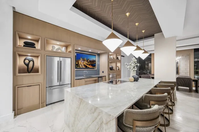 entertaining kitchen with waterfall counter and stainless steel appliances