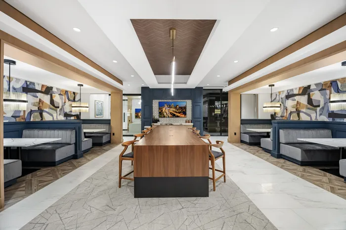 coworking lounge with communal table and 4 booth seating areas
