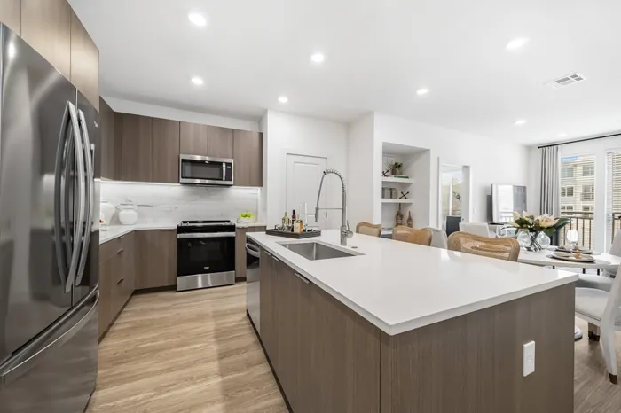 kitchen with stainless steel aplliances and large counter height island with white counters