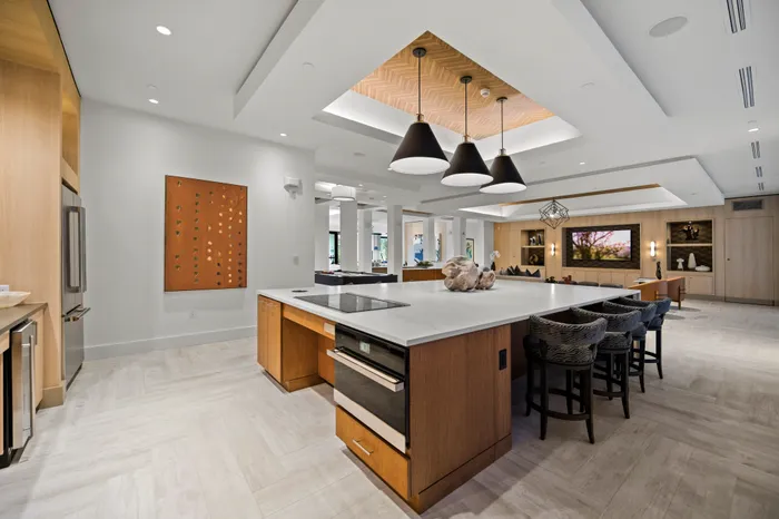 entertaining lounge with counter height seating and fridge, oven, stove, microwave and ice maker