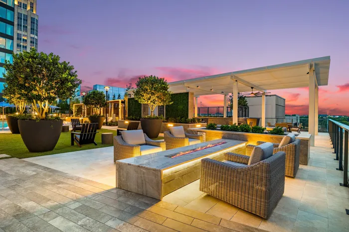 elevated amenity deck with fire pit seating and arbor structure