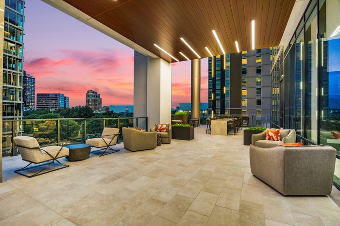 open-air covered terrace with lounge and dining areas