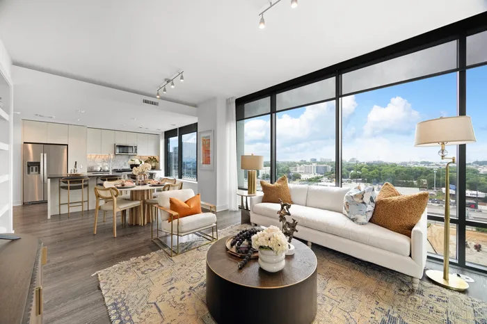 apartment with open-concept living and kitchen area and floor to ceiling windows
