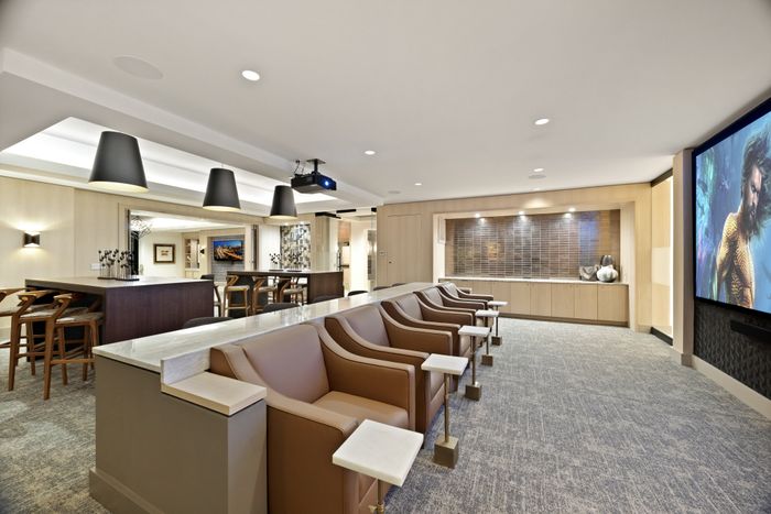 screening lounge with high top seating and soft lounge seating and projector screen