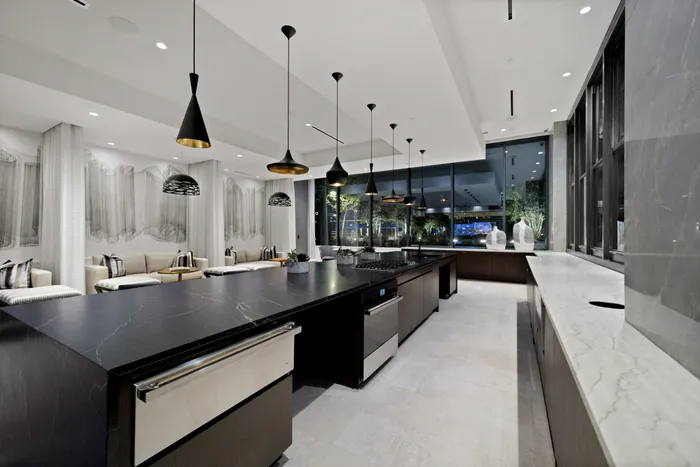 club room with catering kitchen including oven, warming drawers and spacious counter-height counters