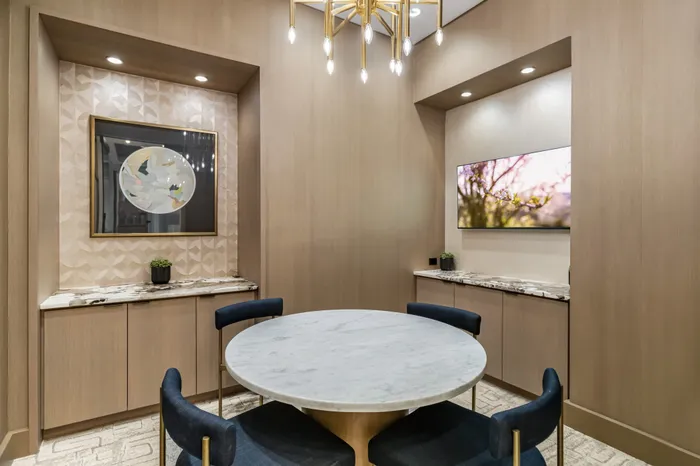 meeting room with round table and 4 chairs with TV on one wall