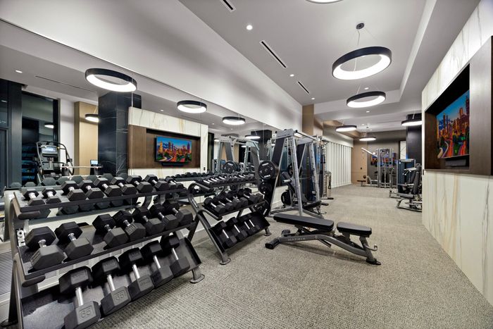 gym with free weights, benches and a smith machine