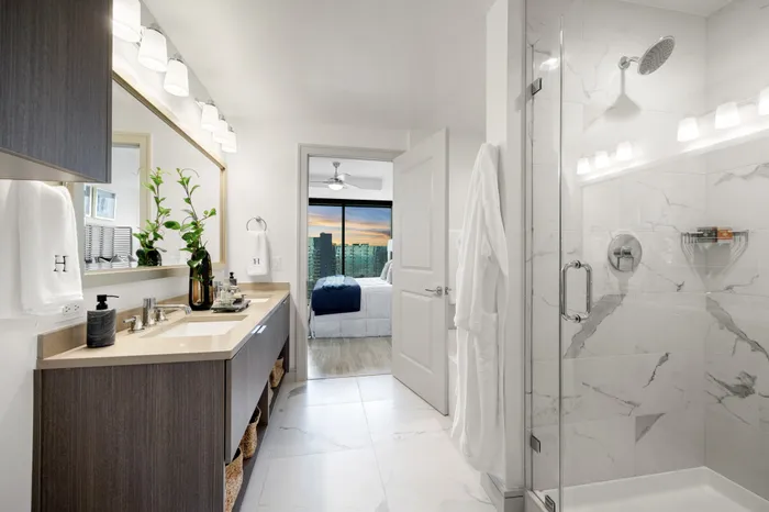 Bathroom with standing shower with glass door and a double vanity