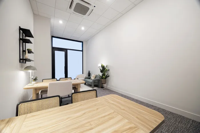 office space outfitted with two desks and sofa seating area