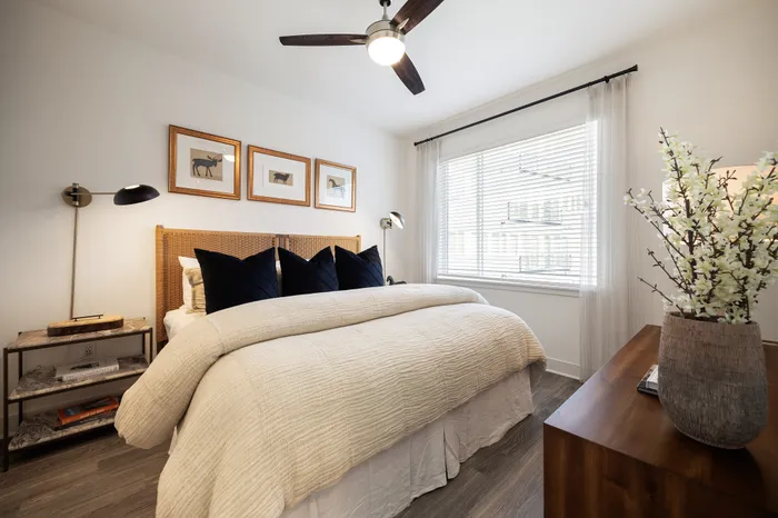 bedroom in apartment with king size bed, nightstands, dresser and ceiling fan