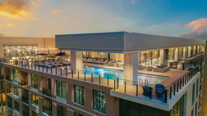 Ariel view of the resort style pool on the terrace with pool chairs, corner sitting area and fireplaces
