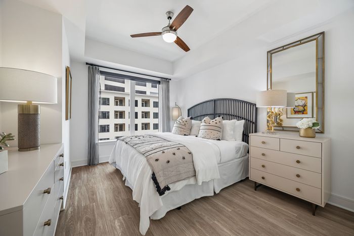 Bedroom with a king size bed, with a dresser besides the bed