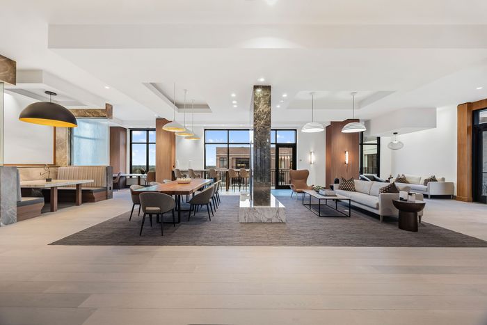 Co-working space with sofa sitting conferernce tables and banquette sitting area