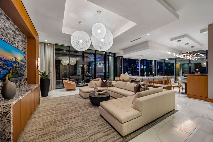 Resident Lounge with sectional sofa sitting sofa chairs a conference table and a TV