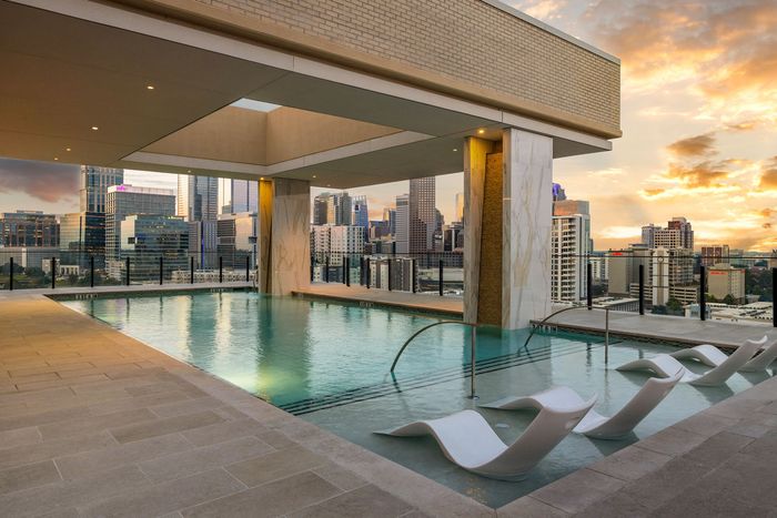 Resort style pool on the terrace with pool chairs overlooking the Dilworth skyline
