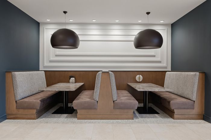 two booths side by side with black pendant lighting above