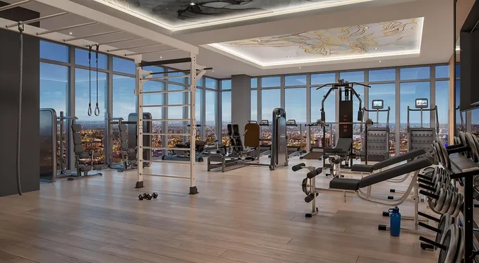 Luxurious high-rise gym with panoramic city views, featuring state-of-the-art fitness equipment and modern design.