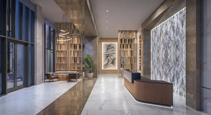 Elegant and spacious lobby featuring modern design elements, marble flooring, and artistic decor with stylish seating areas.