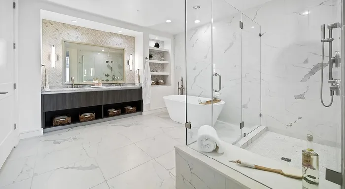 Luxurious bathroom with elegant marble surfaces, a spacious walk-in shower, and a stylish freestanding bathtub creating a serene spa-like retreat.