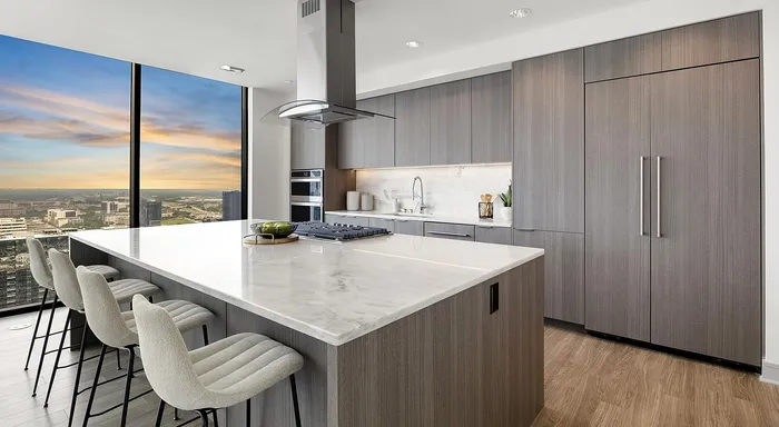 Elegant modern kitchen with panoramic city views, featuring a spacious island, sleek cabinetry, and state-of-the-art appliances.