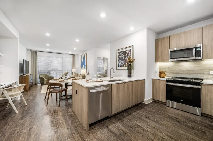 Contemporary apartment with open-concept living space, stylish kitchen, and elegant dining area, ideal for modern living.