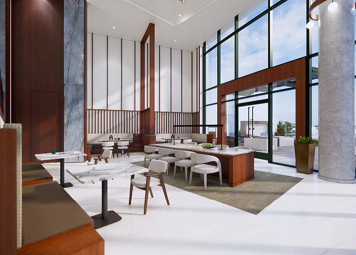 Luxurious apartment lobby with high ceilings, modern marble tables, and expansive glass walls offering natural light.
