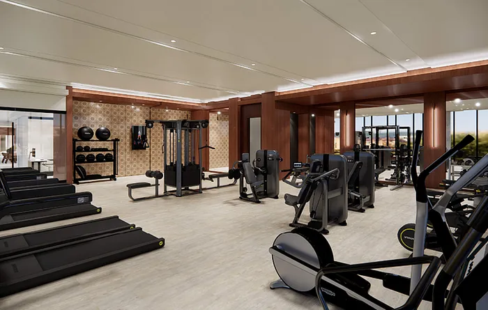 Luxury fitness center with modern equipment, featuring treadmills, weight machines, and sleek wooden accents.