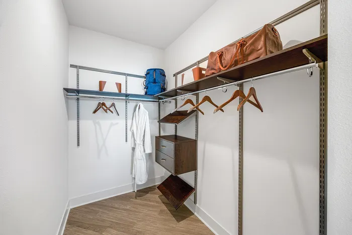 Luxurious walk-in closet with sleek shelving, modern hangers, and elegant storage solutions for a sophisticated lifestyle.
