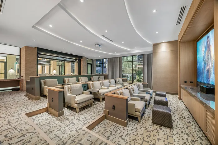 Luxurious private theater room with plush seating, elegant lighting, and modern design, ideal for an immersive movie experience.